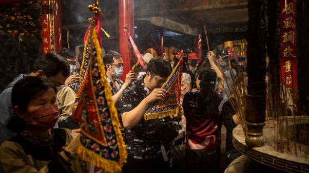 People pay their respects to the sea goddess, Mazu, at a temple in Taiwan during the first day of the 2023 Dajia Mazu Pilgrimage.