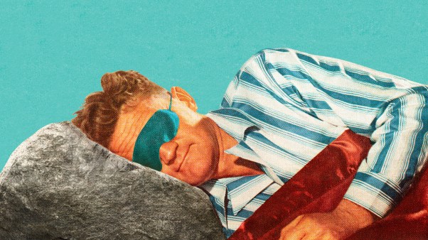 A man sleeping with a rock for a pillow