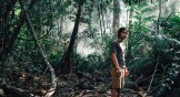 A film still showing the main character in the jungle.