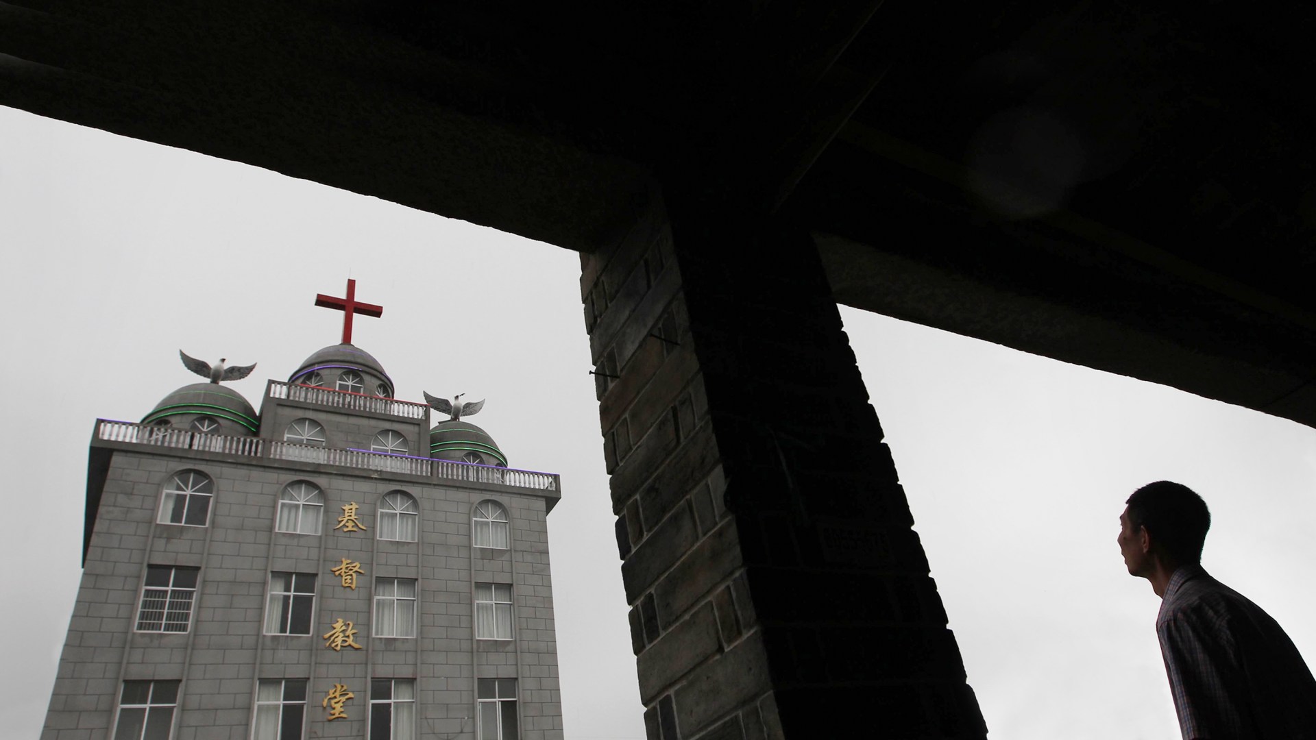 A man looking at the Lingbo Church in China.