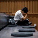 A Chinese student sitting and studying in a classroom