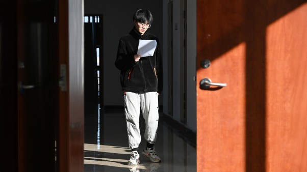 A student walking the halls of a school in China.